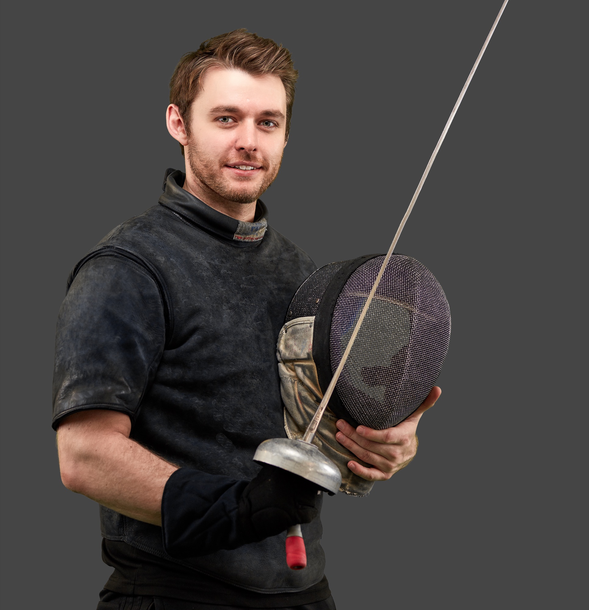 Coach Nick Arlington with epee and mask